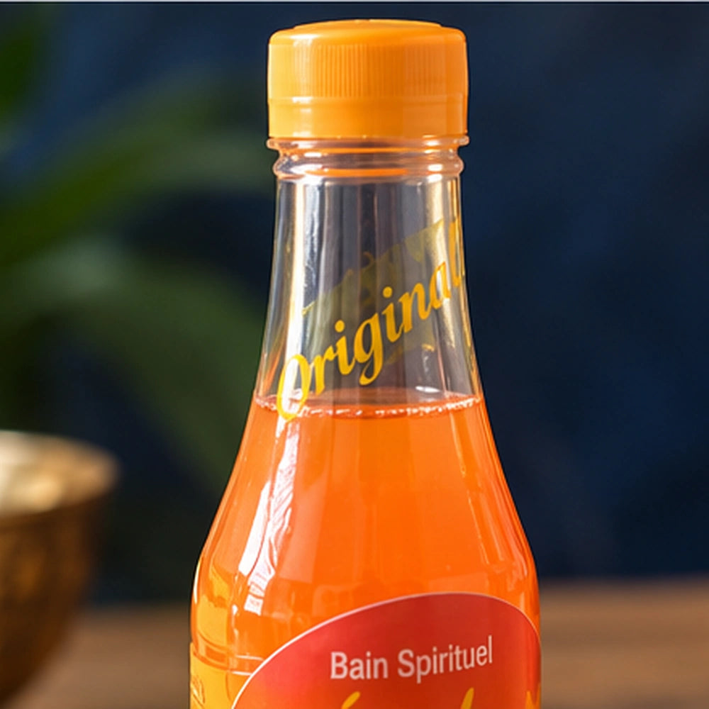 Gros plan sur le bouchon orange et le col du Bain Spirituel Étoile Activée, avec le marquage Original en lettres dorées.