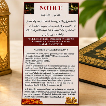 Notice du Savon Al Baraka mise en scène près d’un livre, détaillant le rituel avec l’essence Rouboutou.